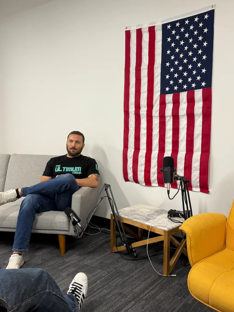 Jerrod Appenzeller at the Ultimum office in Des Moines, seated under an American flag
